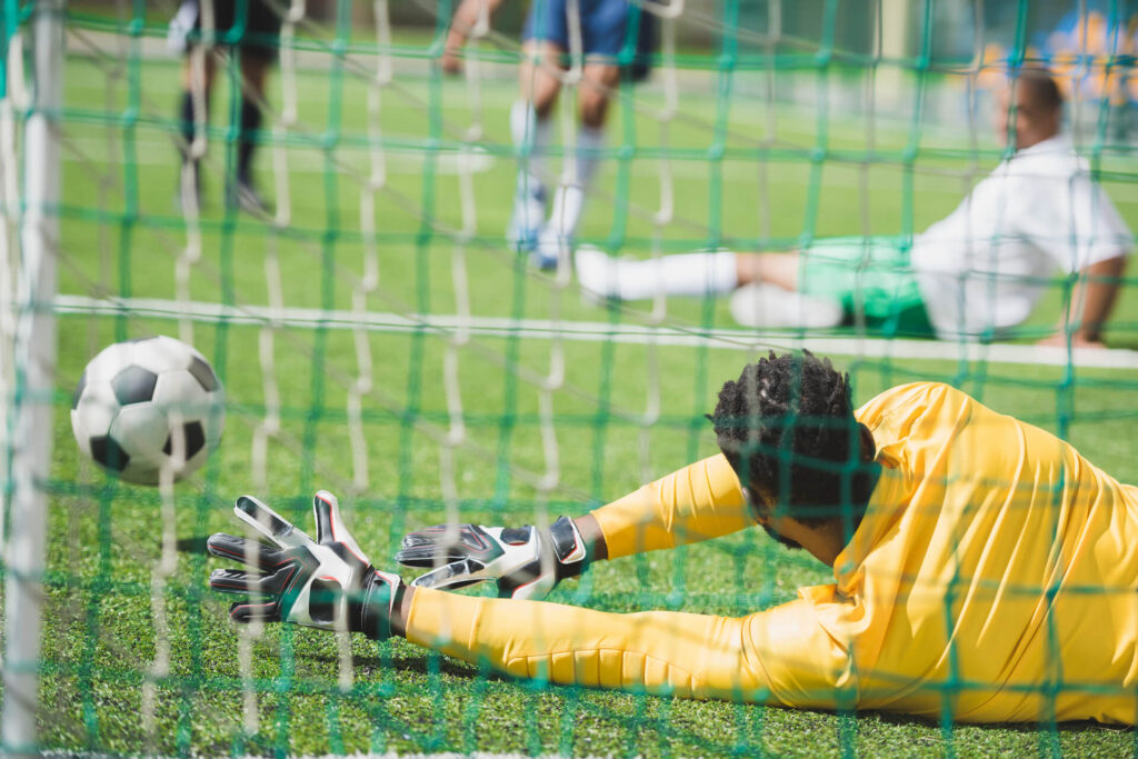 back-view-of-goalkeeper-catching-ball-during-socce-2021-08-29-11-18-39-utc.jpg