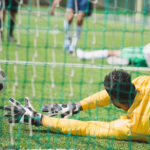 back-view-of-goalkeeper-catching-ball-during-socce-2021-08-29-11-18-39-utc.jpg